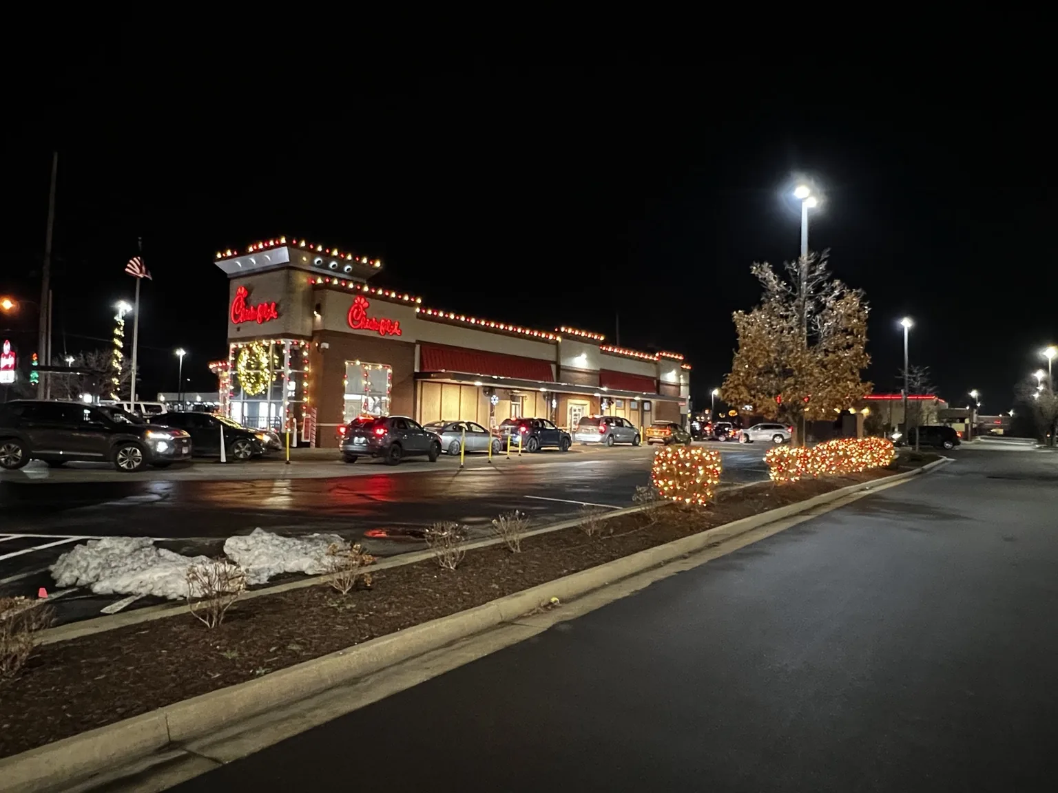 Commercial restaurant roofline and landscape lit for Christmas at night