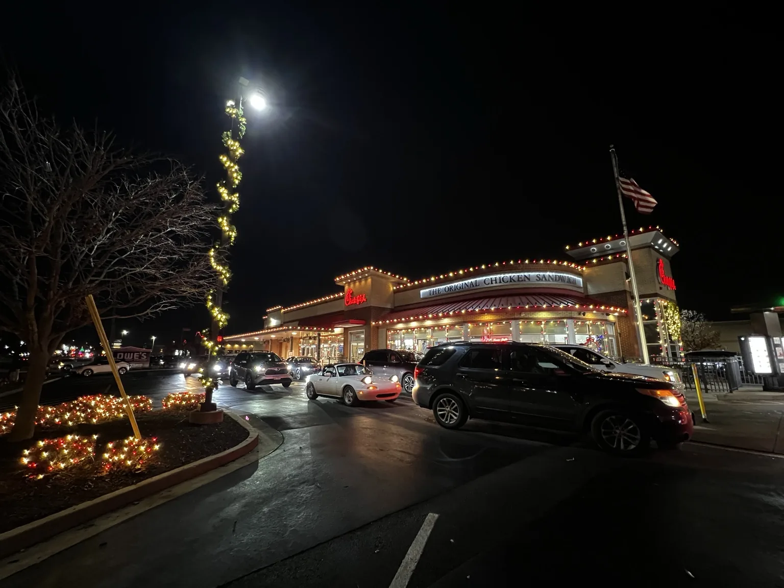 Wide night view of a commercial Christmas lighting installation