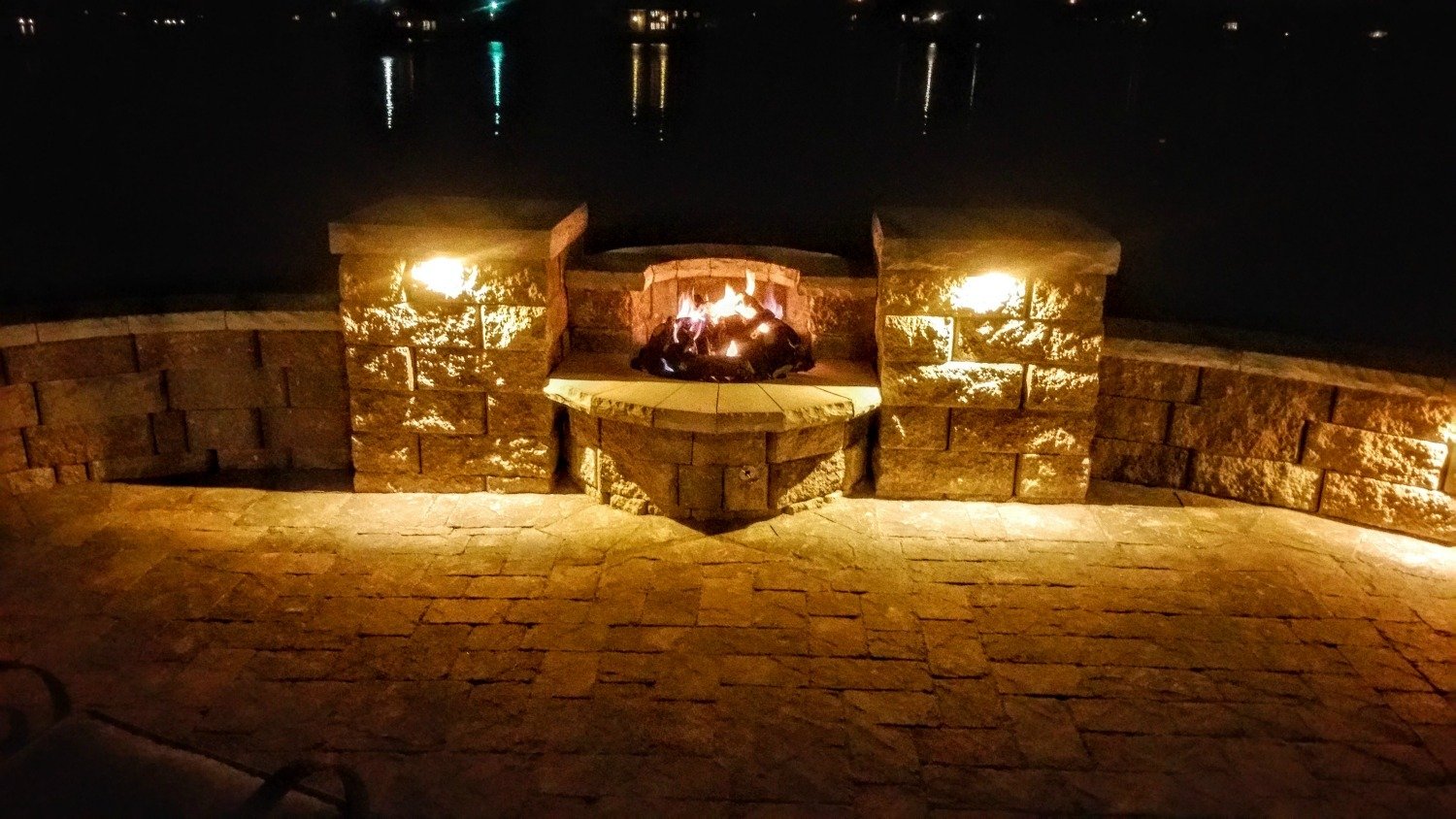 Purple accent lighting around a fire-pit patio