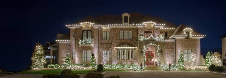 Large-home Christmas-light display with roofline and landscape lighting