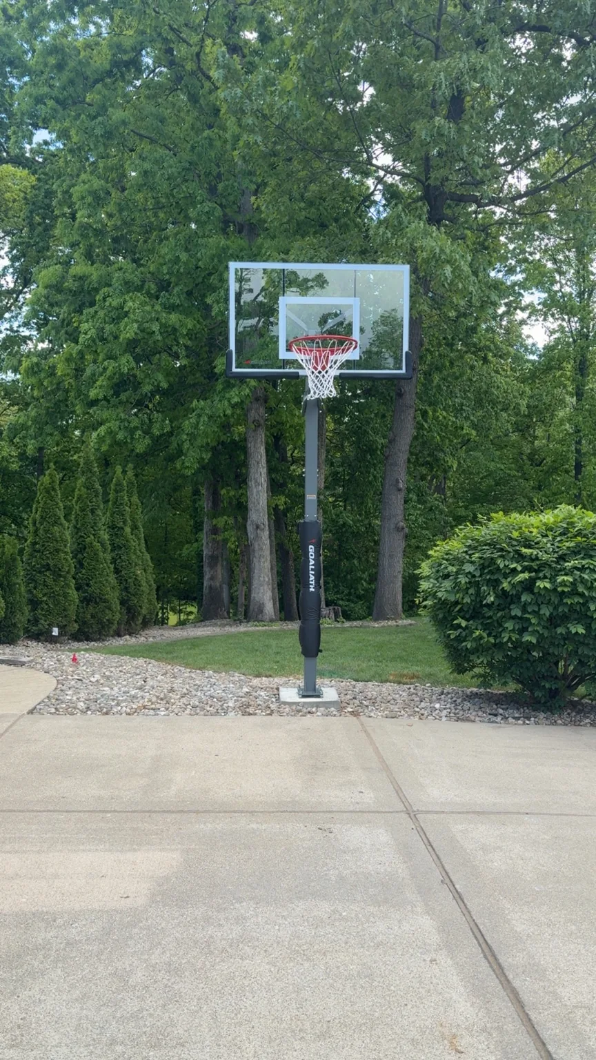 Completed Xpress in-ground basketball hoop beside a driveway
