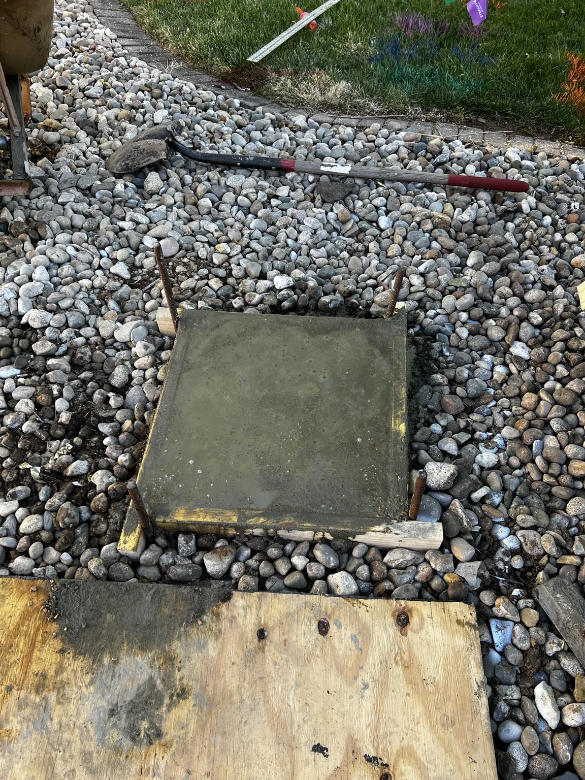 Fresh concrete footing finished at the driveway edge