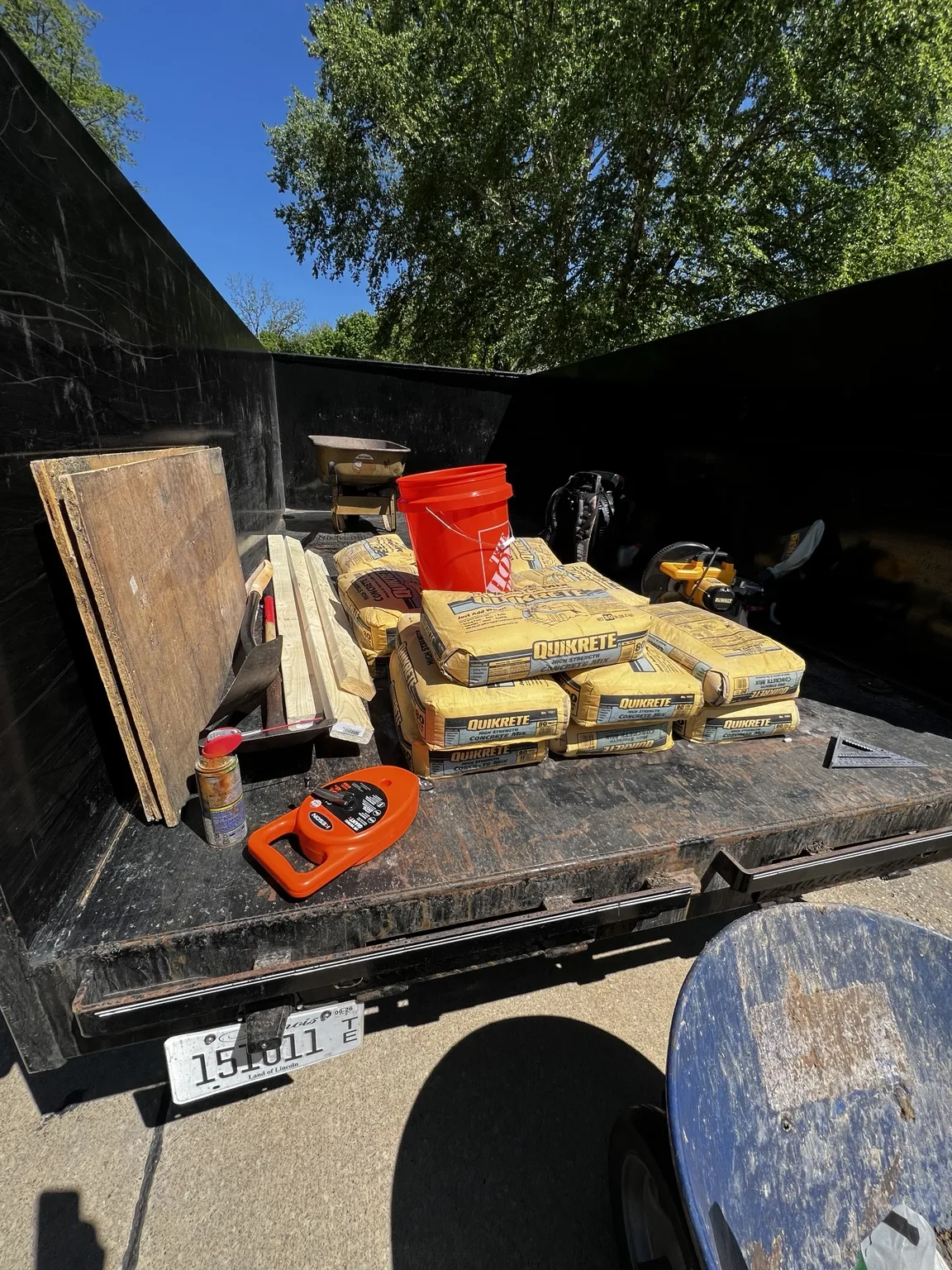 Materials and tools staged for the residential basketball hoop footing