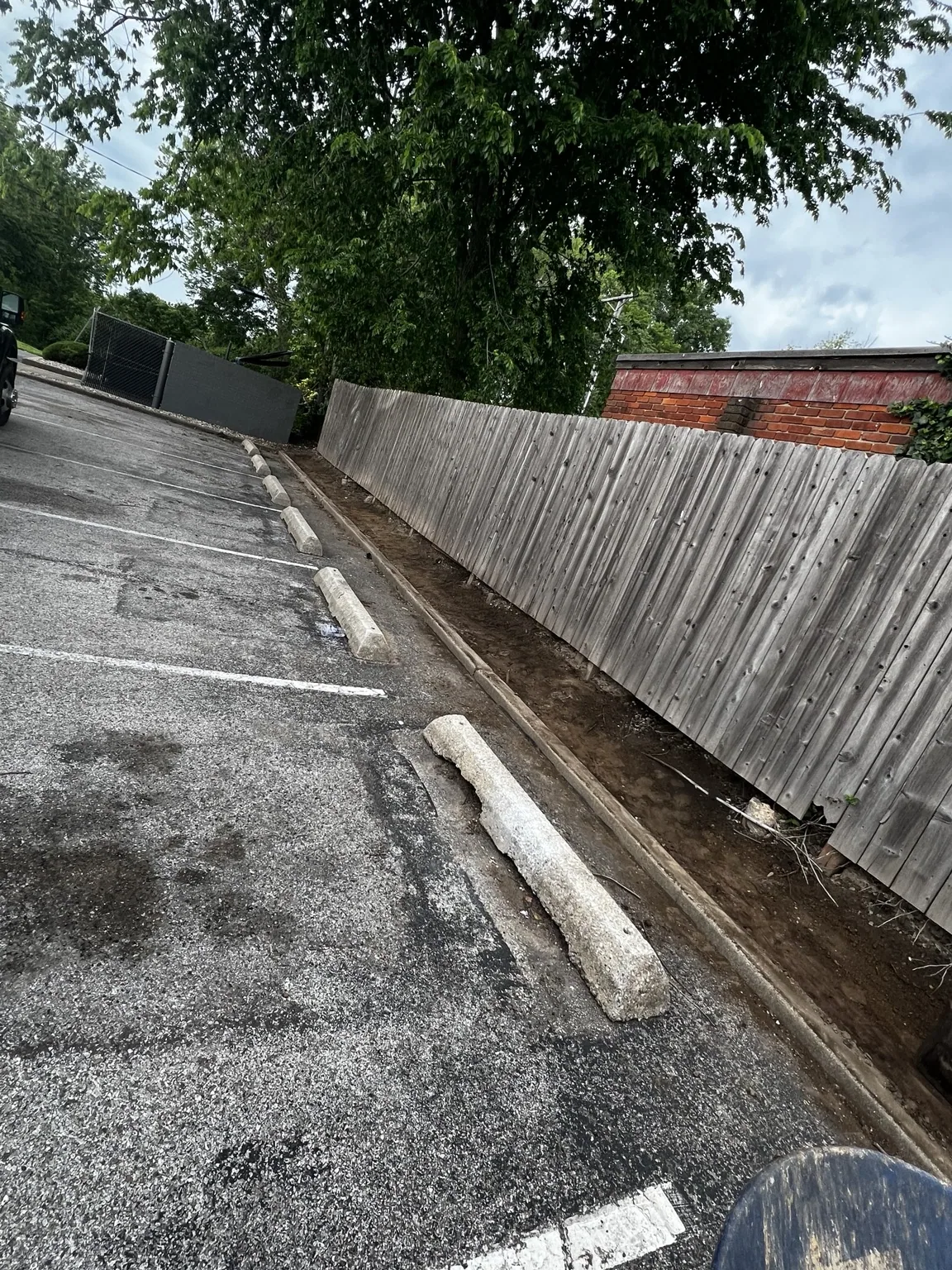 Fence-to-curb strip brought down to the appropriate height