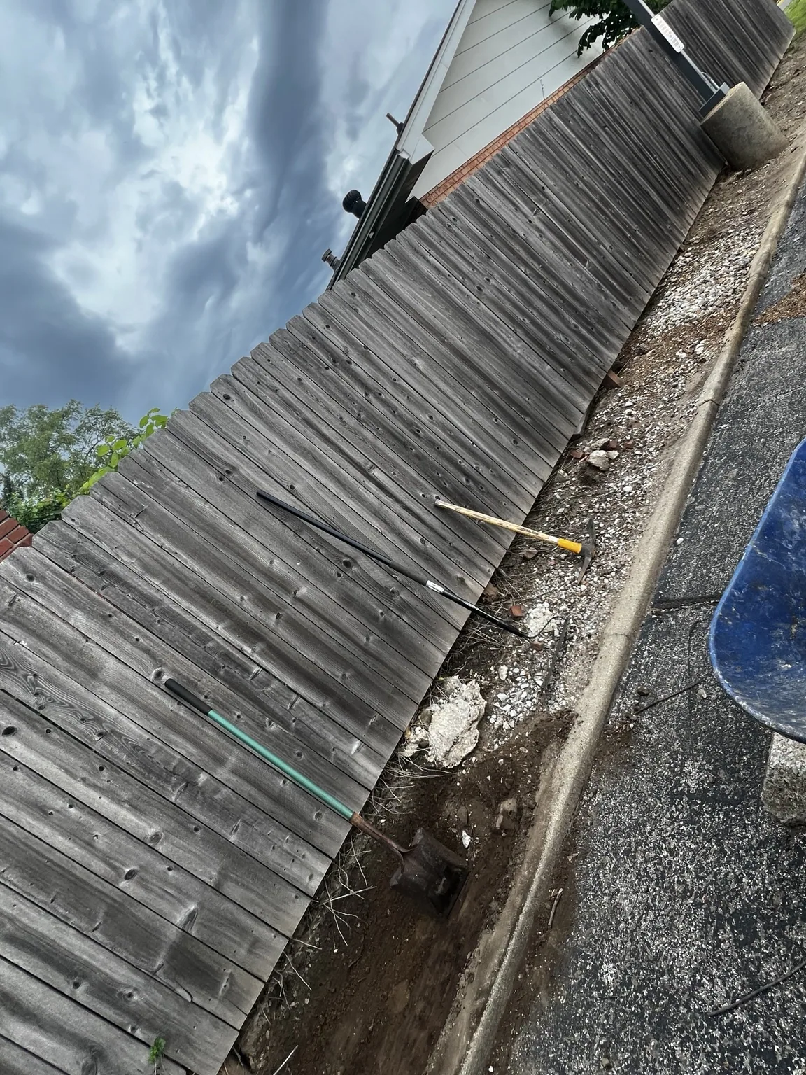 Removing old material from the fence-to-curb strip
