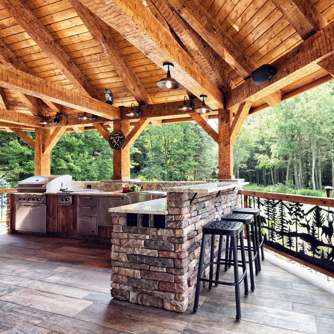 Covered stone outdoor kitchen with bar seating