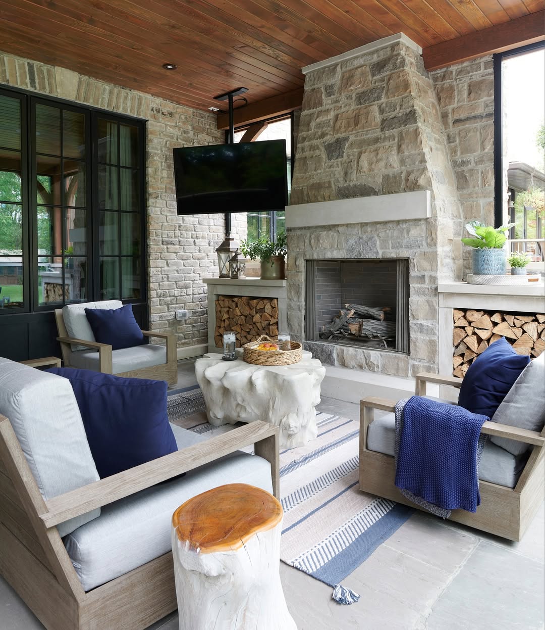 Covered stone fireplace with seating and firewood niches