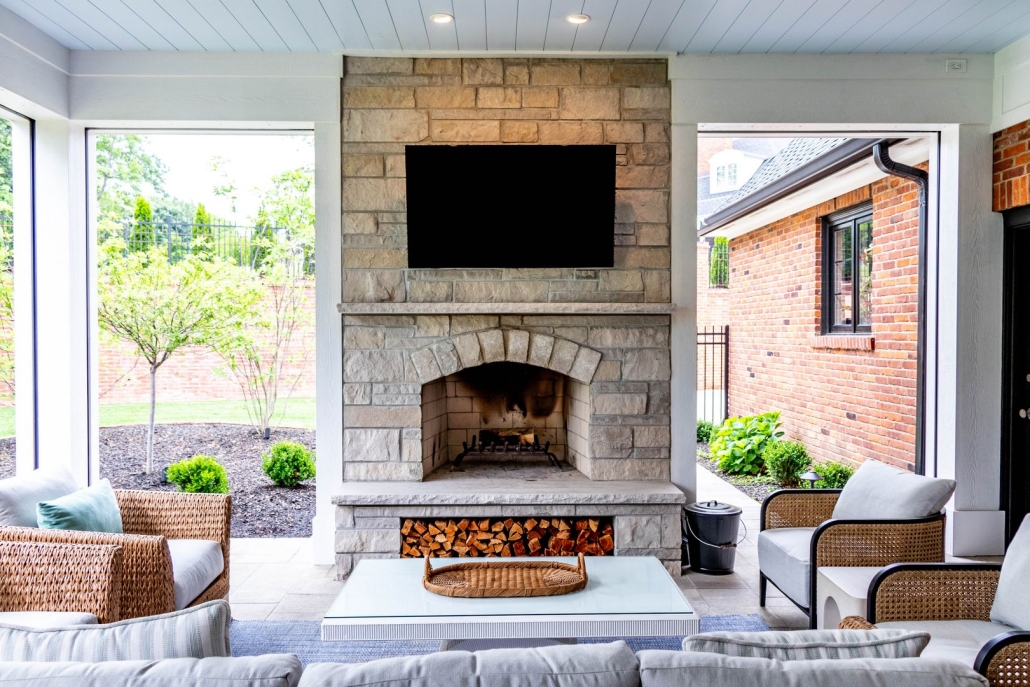 Light stone fireplace in a covered outdoor lounge