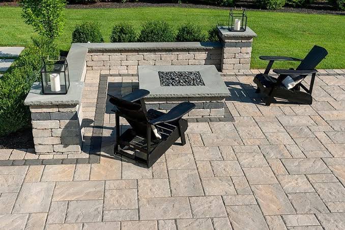 Paver patio with square fire pit and seat wall