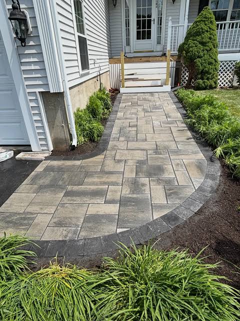 Paver walkway with curved border leading to a front porch