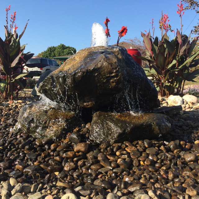 Natural drilled boulder fountain