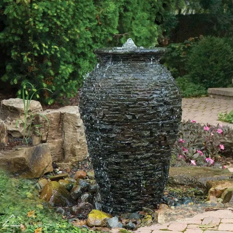 Stacked slate urn in a landscaped setting